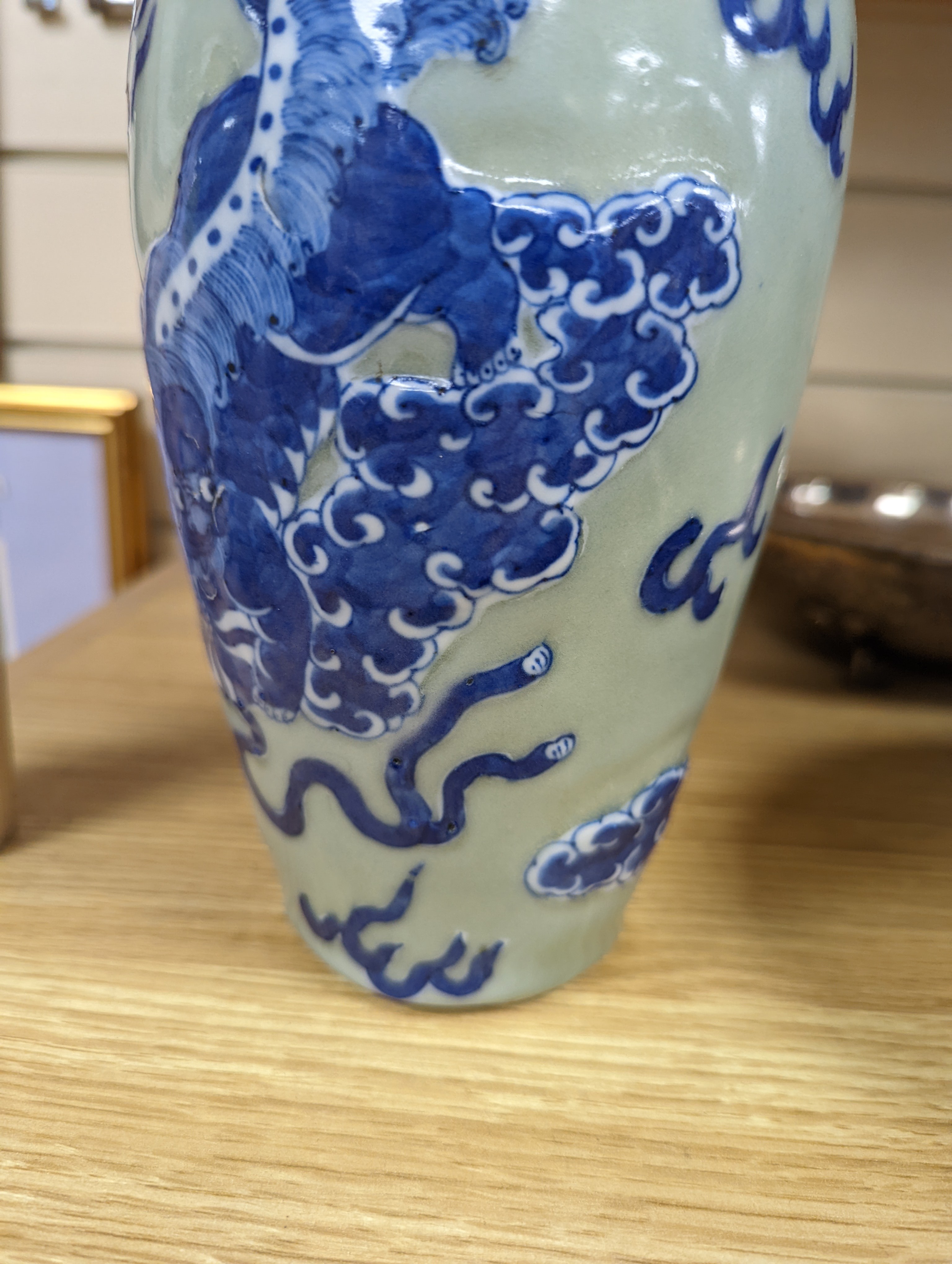 A Chinese celadon glazed vase, 24cm and a Chinese famille rose teapot and matching cream jug, a.f.